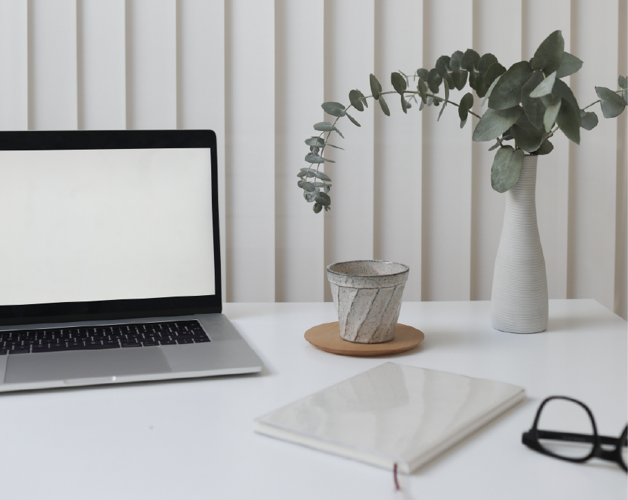 Desk with glasses and laptop